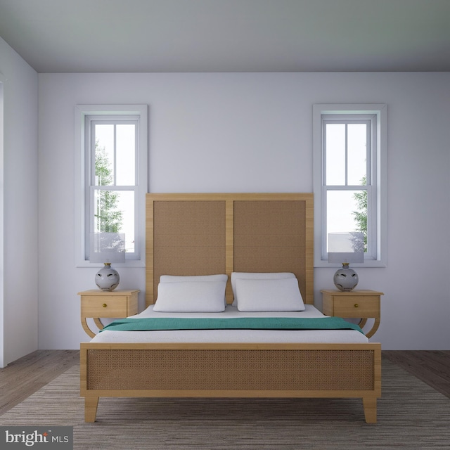 bedroom featuring hardwood / wood-style flooring and multiple windows