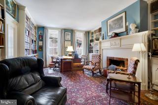 living room featuring built in features and a brick fireplace