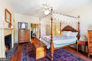 bedroom featuring ceiling fan and dark hardwood / wood-style flooring