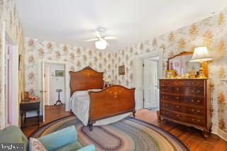 bedroom featuring hardwood / wood-style flooring and ceiling fan