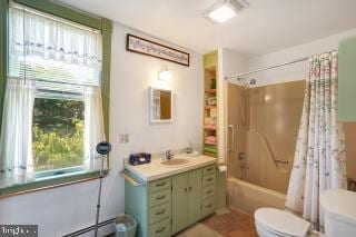 full bathroom featuring vanity, toilet, shower / bath combo, and tile patterned flooring