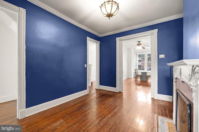 interior space featuring hardwood / wood-style flooring, ornamental molding, and ceiling fan