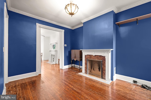 unfurnished living room featuring ornamental molding, a fireplace, and hardwood / wood-style floors