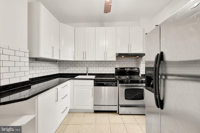 kitchen featuring white cabinets, light tile patterned floors, appliances with stainless steel finishes, and sink