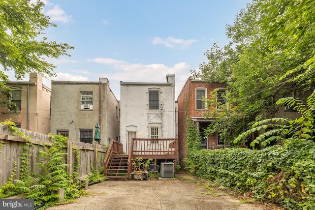 back of property with central air condition unit and a wooden deck