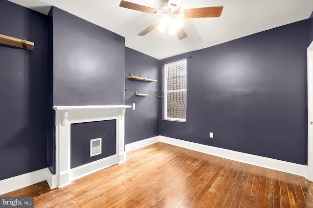 unfurnished living room featuring wood-type flooring and ceiling fan