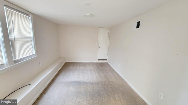 empty room featuring light carpet