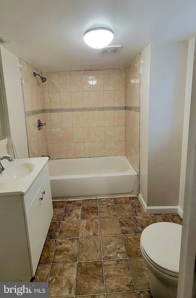 full bathroom with vanity, toilet, and tiled shower / bath