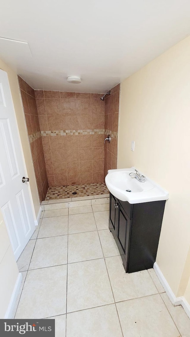 bathroom featuring vanity, tiled shower, and tile patterned floors