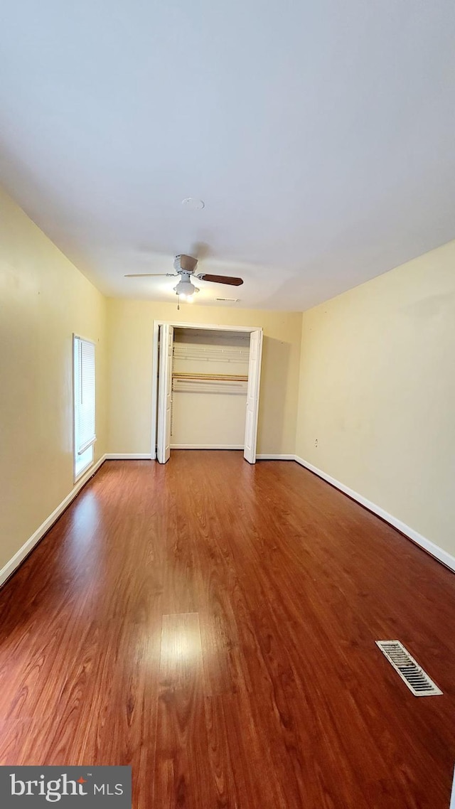 unfurnished living room with ceiling fan and wood-type flooring