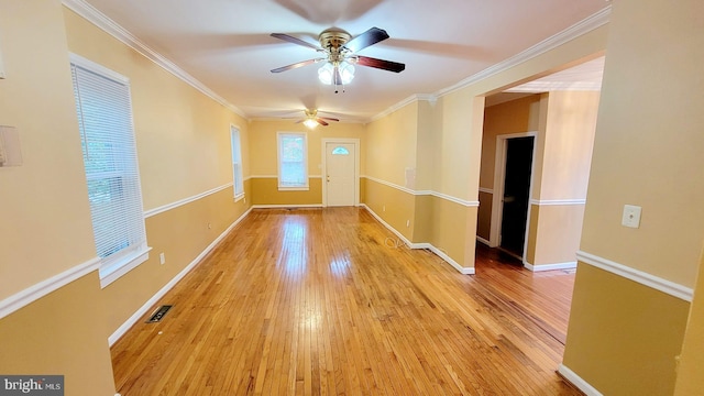 entryway featuring light wood-type flooring, ornamental molding, and ceiling fan