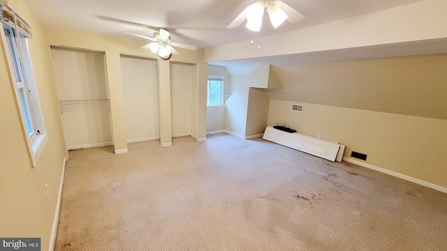 bonus room featuring light carpet, vaulted ceiling, and ceiling fan