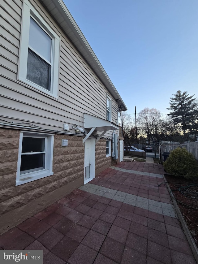 view of side of property with a patio area