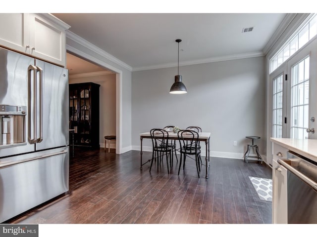 dining room featuring dark hardwood / wood-style flooring and crown molding