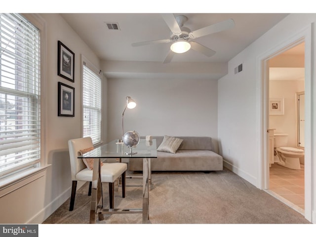 carpeted dining space featuring ceiling fan