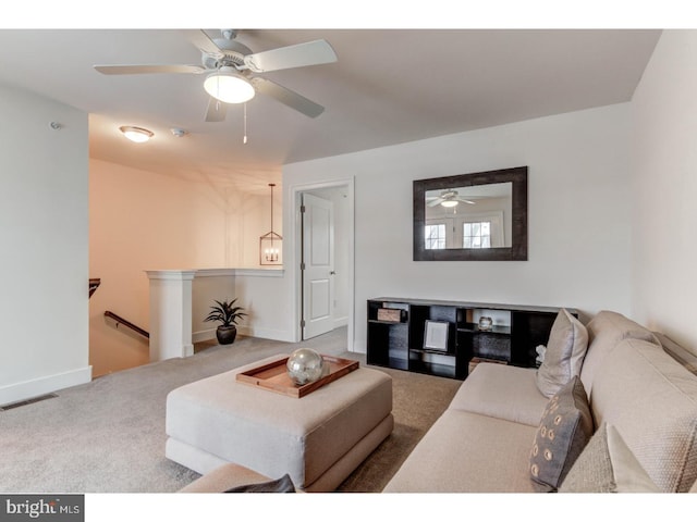 living room with ceiling fan and carpet floors