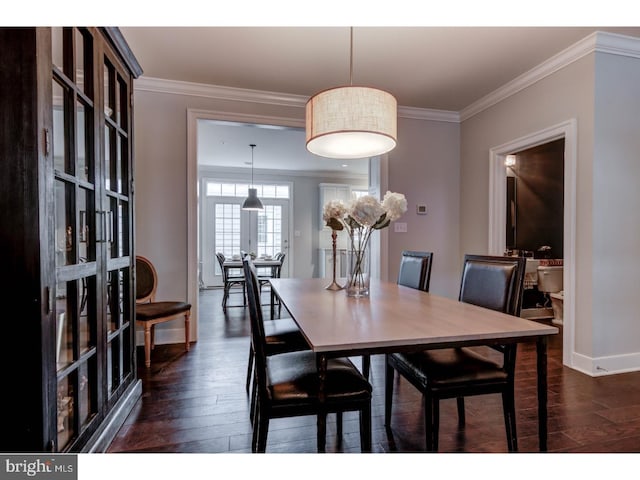 dining room featuring dark hardwood / wood-style flooring and ornamental molding