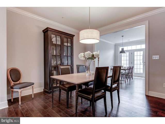 dining room with ornamental molding, dark wood-type flooring, and french doors