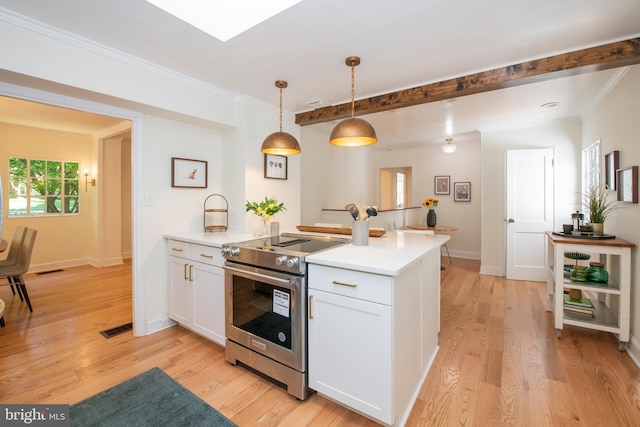 kitchen with white cabinets, stainless steel stove, light hardwood / wood-style floors, and decorative light fixtures