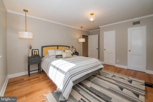 bedroom featuring light wood-type flooring and ornamental molding