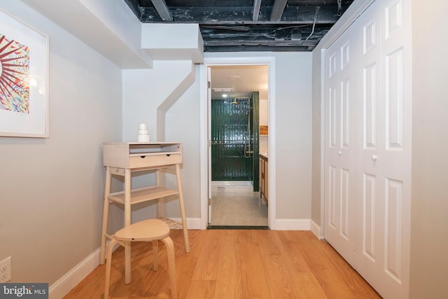 corridor with light hardwood / wood-style floors