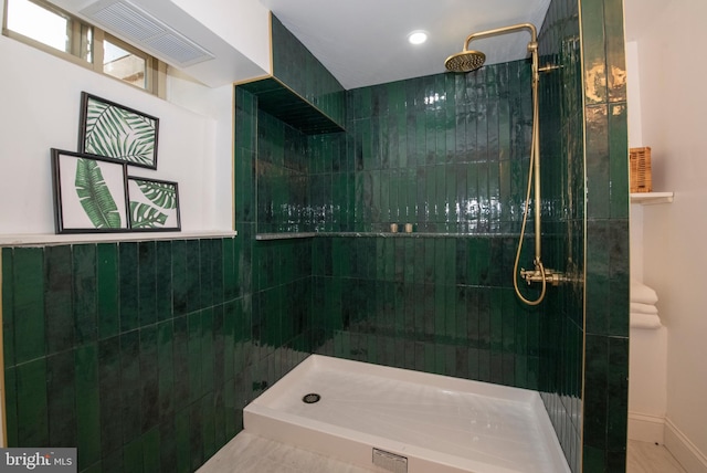 bathroom with a tile shower