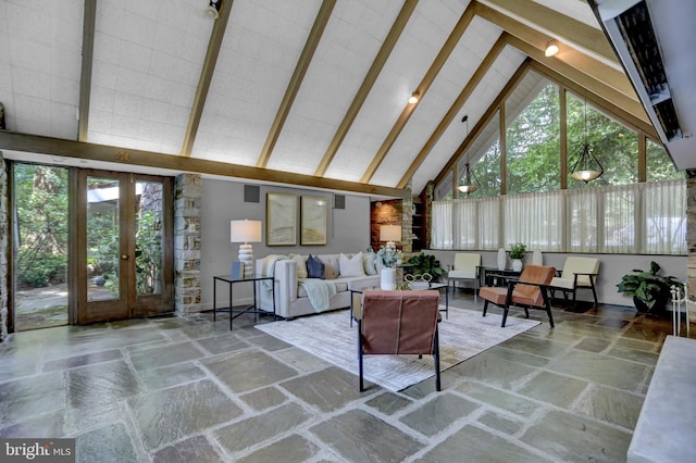 sunroom / solarium with vaulted ceiling with beams, a healthy amount of sunlight, and french doors