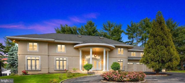 view of front of property featuring a garage and a yard