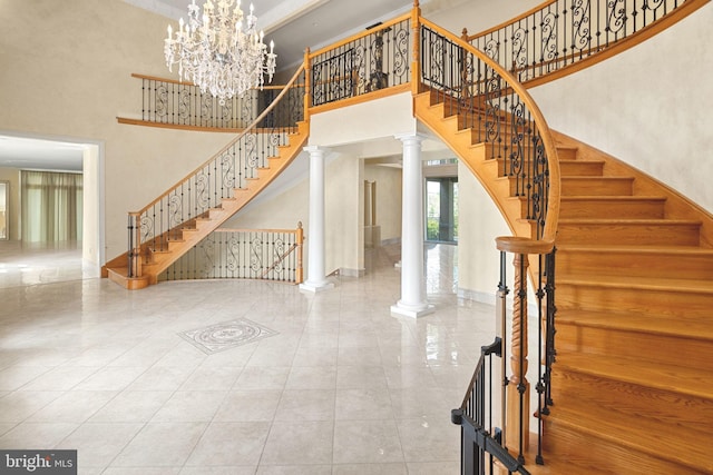 interior space featuring ornate columns, a high ceiling, and a notable chandelier