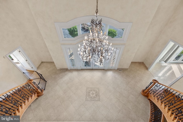 interior space featuring a high ceiling and an inviting chandelier