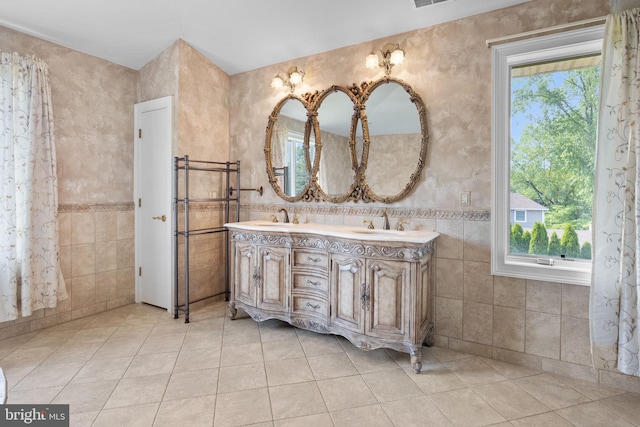 bathroom featuring tile patterned floors, vanity, and tile walls