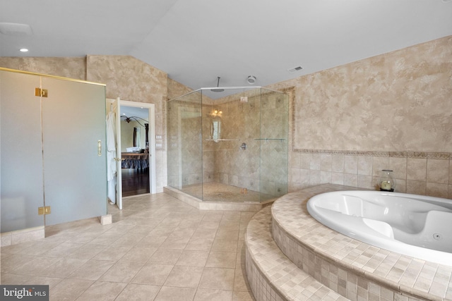 bathroom featuring tile patterned flooring, shower with separate bathtub, and vaulted ceiling