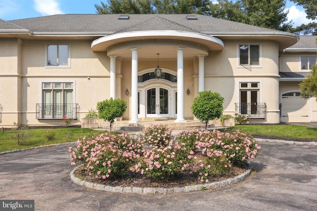 entrance to property with french doors and a garage