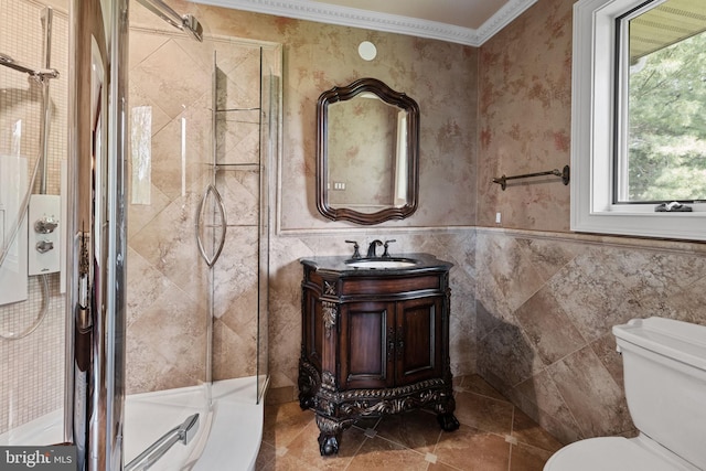 bathroom with crown molding, vanity, an enclosed shower, and toilet