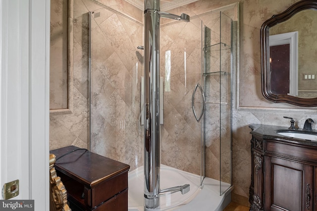 bathroom featuring vanity and a shower with shower door