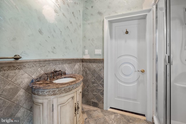 bathroom with vanity and tile walls