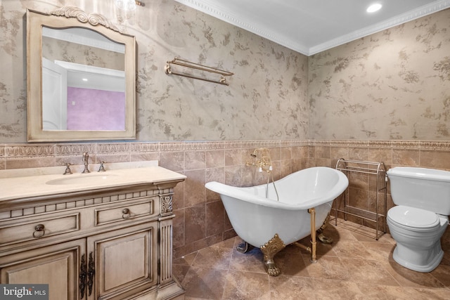 bathroom with a tub, toilet, vanity, tile walls, and ornamental molding