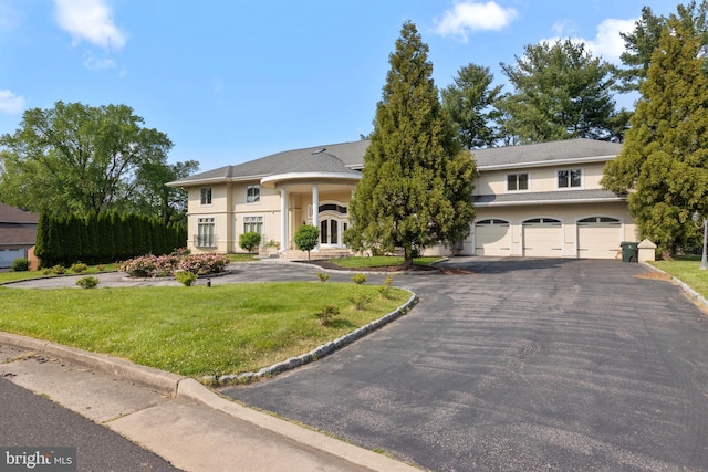 view of front of home with a garage and a front yard