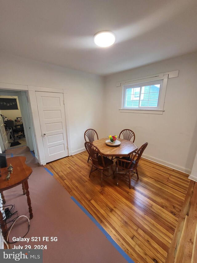 dining space with wood-type flooring