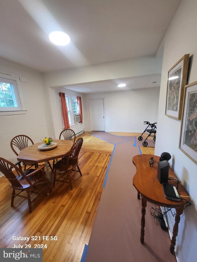 dining room featuring wood-type flooring and cooling unit