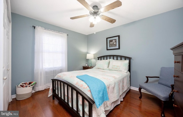 bedroom with ceiling fan, wood finished floors, and baseboards