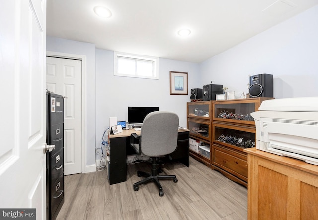 office space featuring recessed lighting, baseboards, and light wood finished floors