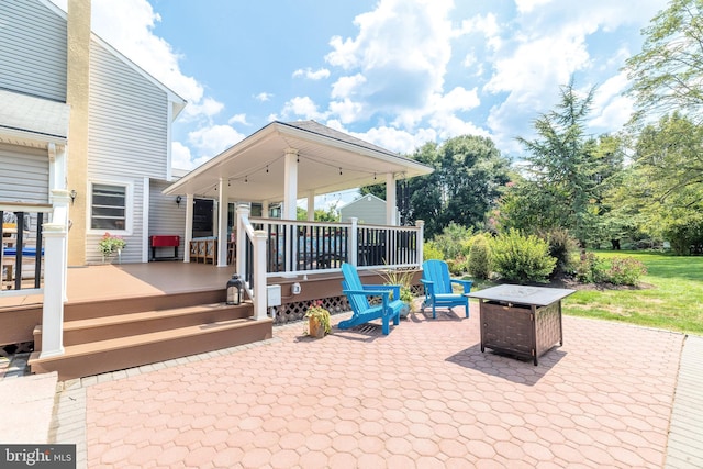 view of patio featuring an outdoor fire pit and a wooden deck