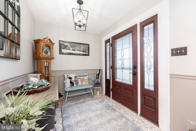 entryway with a notable chandelier and wainscoting