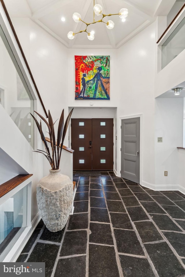 foyer entrance with an inviting chandelier and a high ceiling