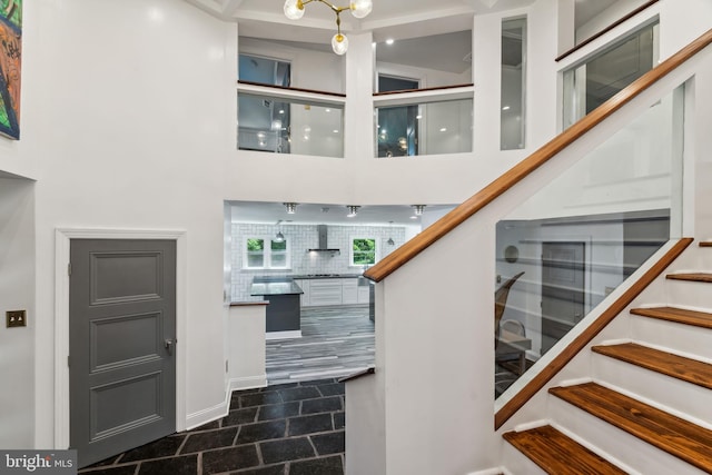 tiled entryway featuring a high ceiling