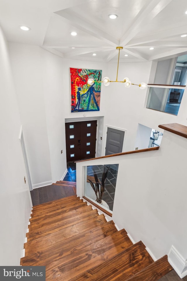 staircase with hardwood / wood-style floors