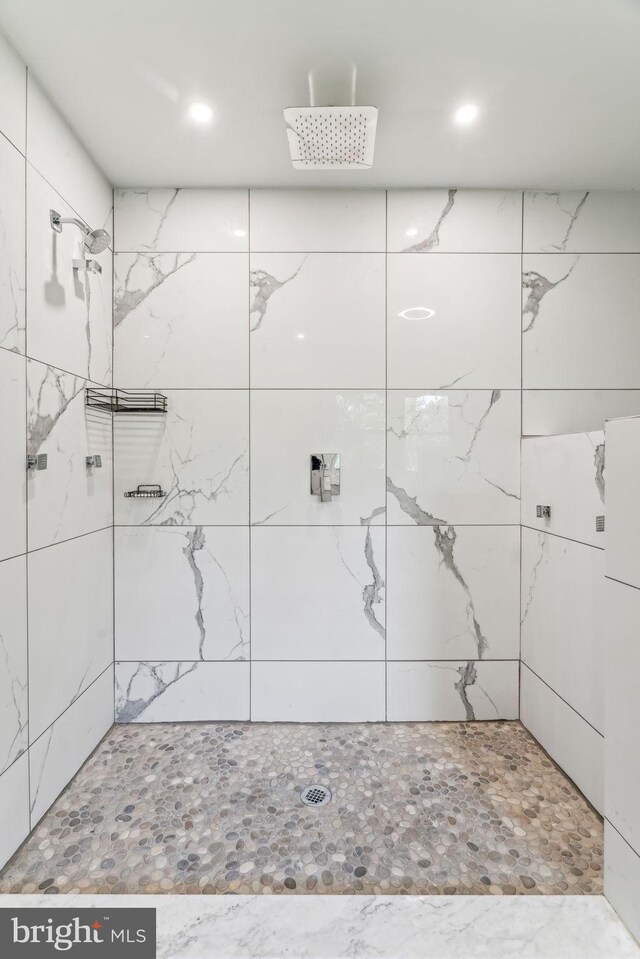 bathroom with tile walls, tasteful backsplash, and double sink vanity