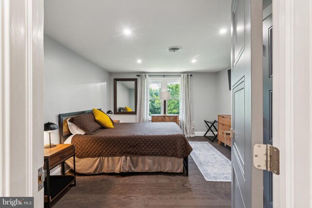 bedroom with dark hardwood / wood-style flooring