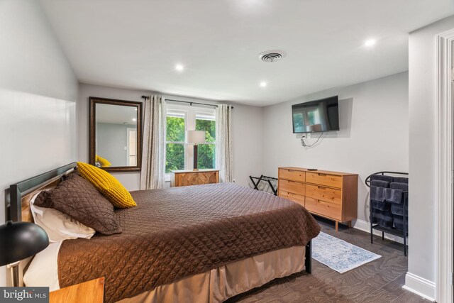 bedroom with dark hardwood / wood-style floors